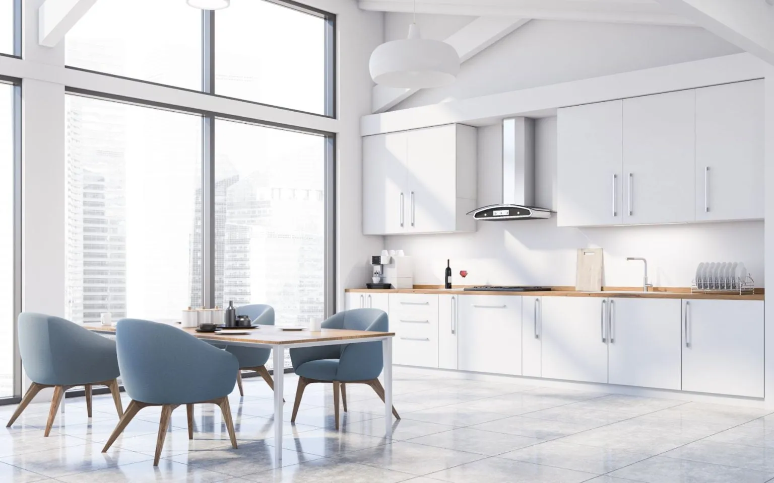Contemporary kitchen with sleek white cabinets and vibrant blue chairs, highlighting a recent remodeling project.
