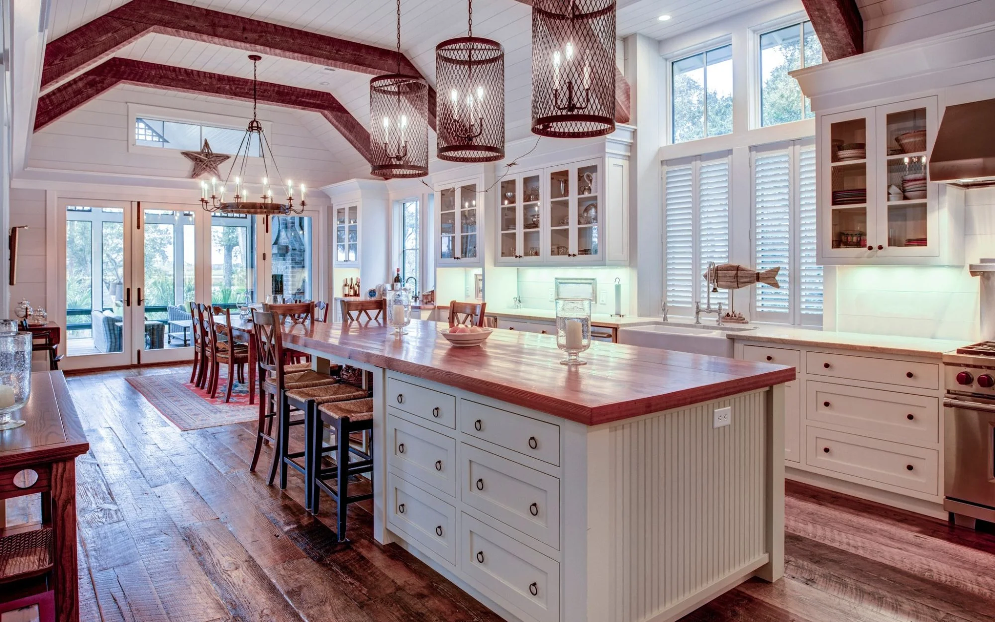 A kitchen with a central island and polished wooden floors, designed for functionality and style.