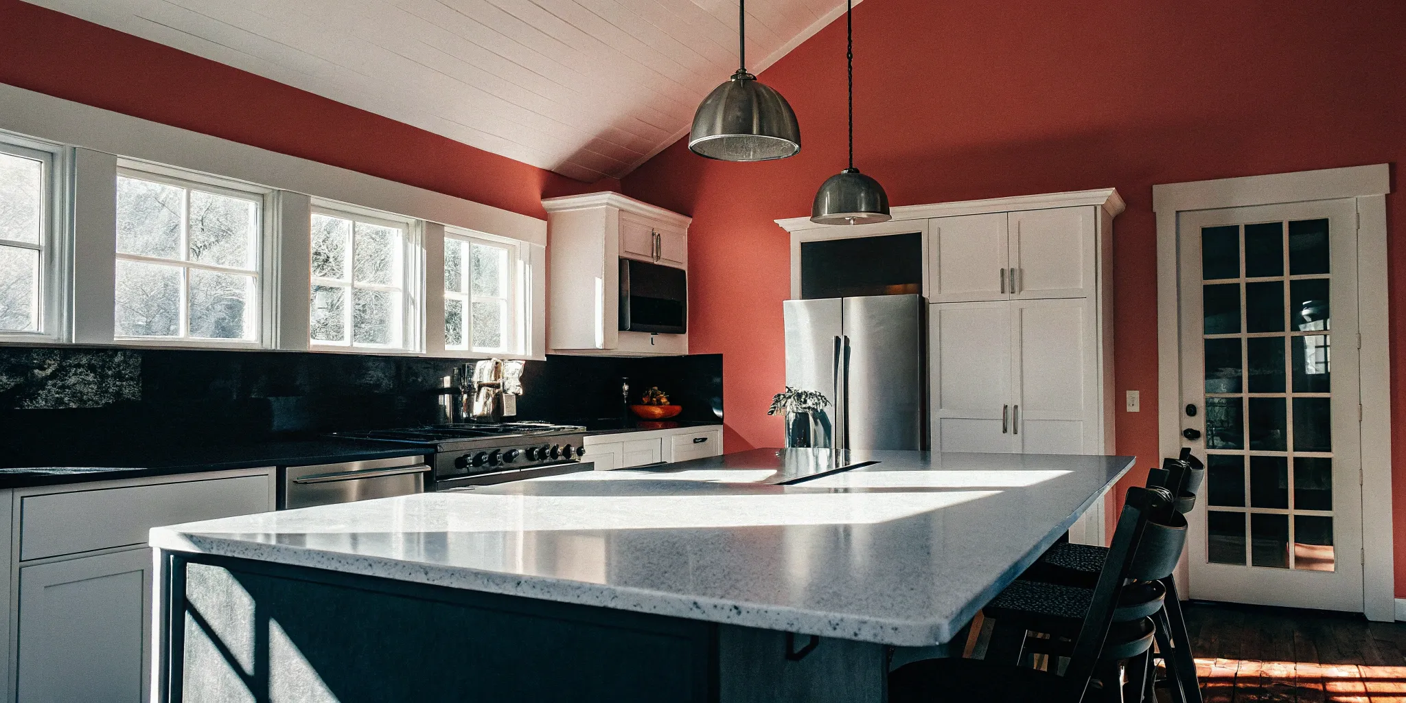 A general contractor kitchen remodel with white cabinets, stainless steel appliances, and a large island.