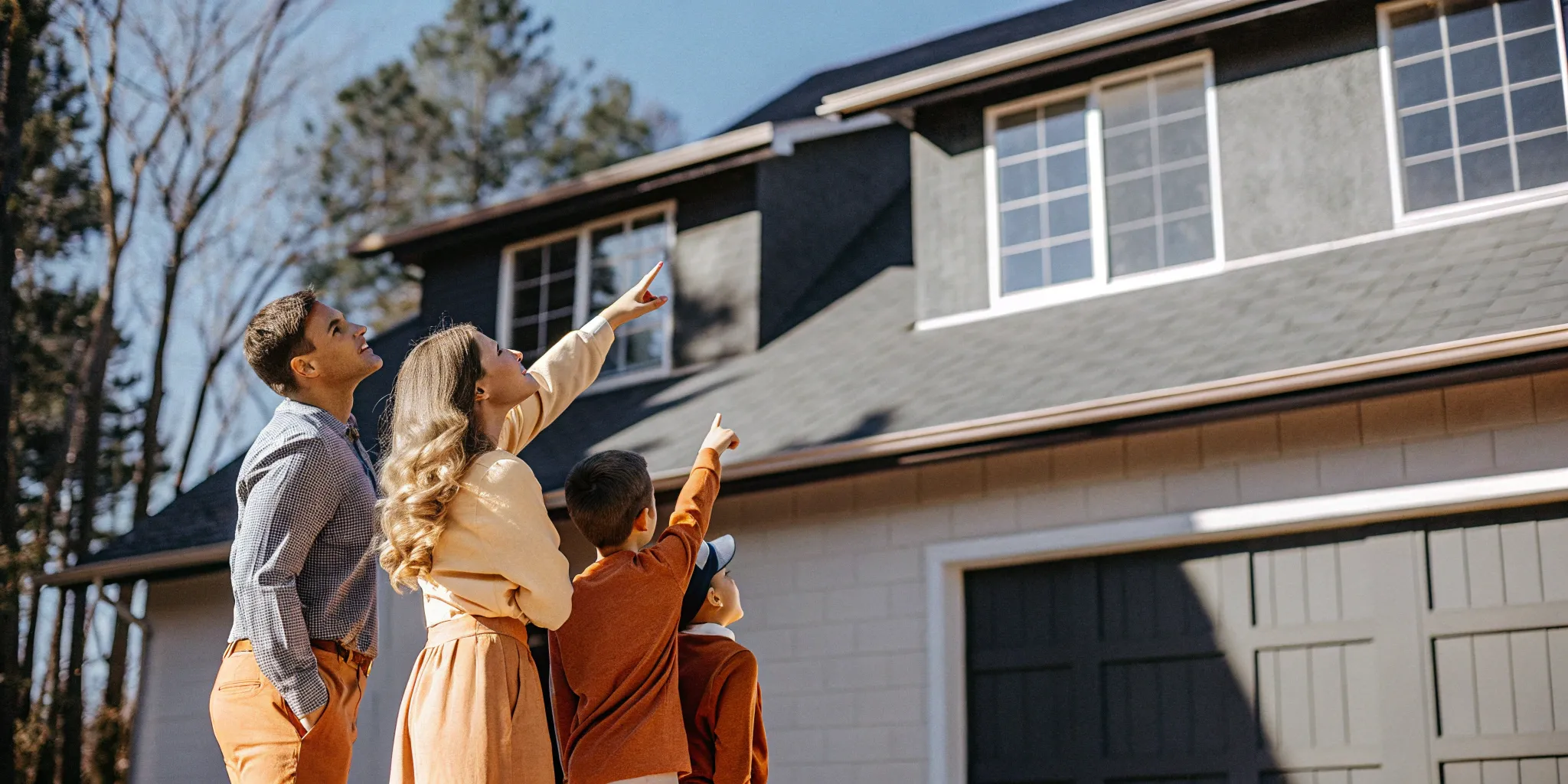 Family in front of their one-story home planning a second story addition.