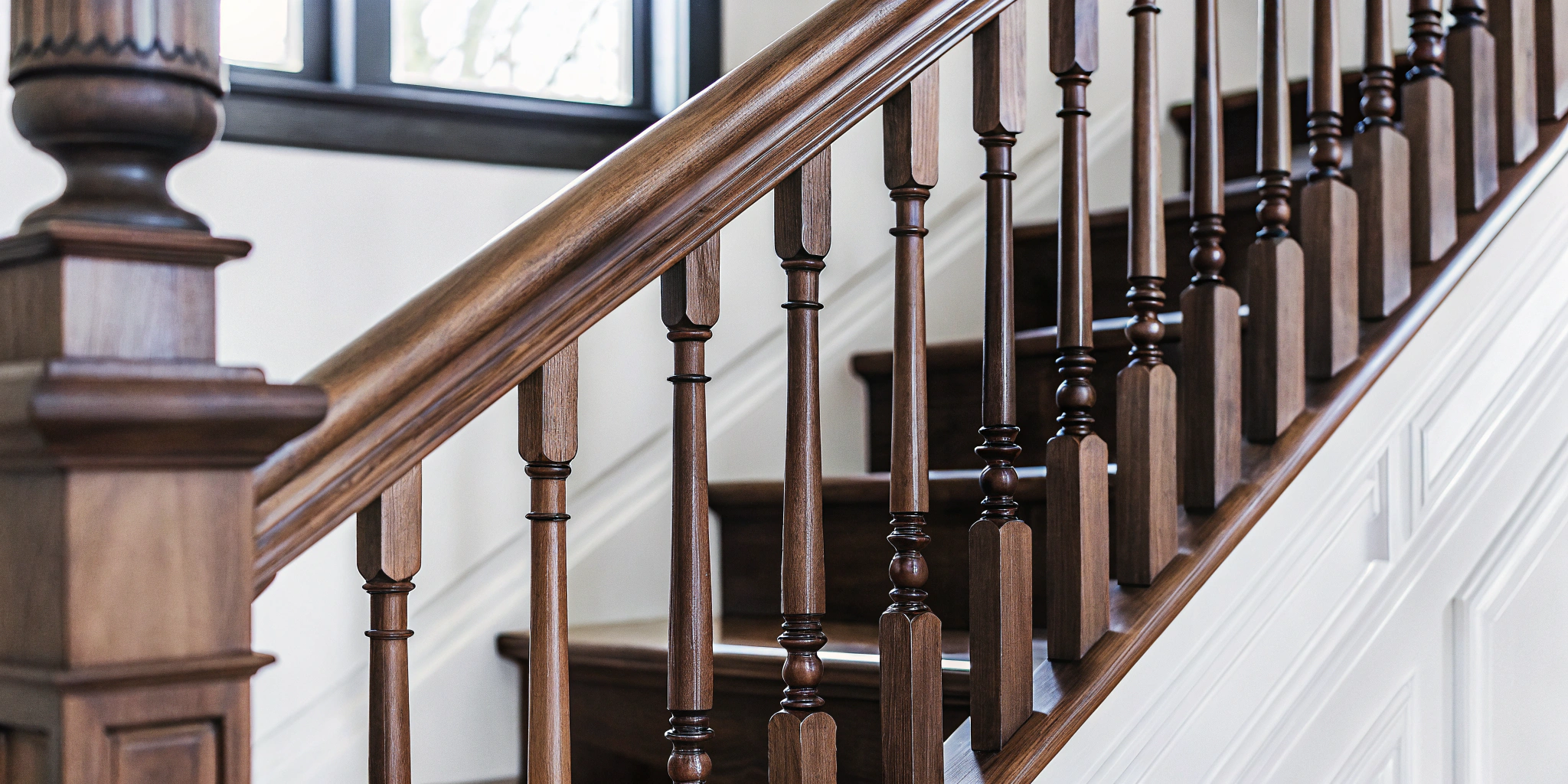 An example of classic finish carpentry on a wooden stair railing.