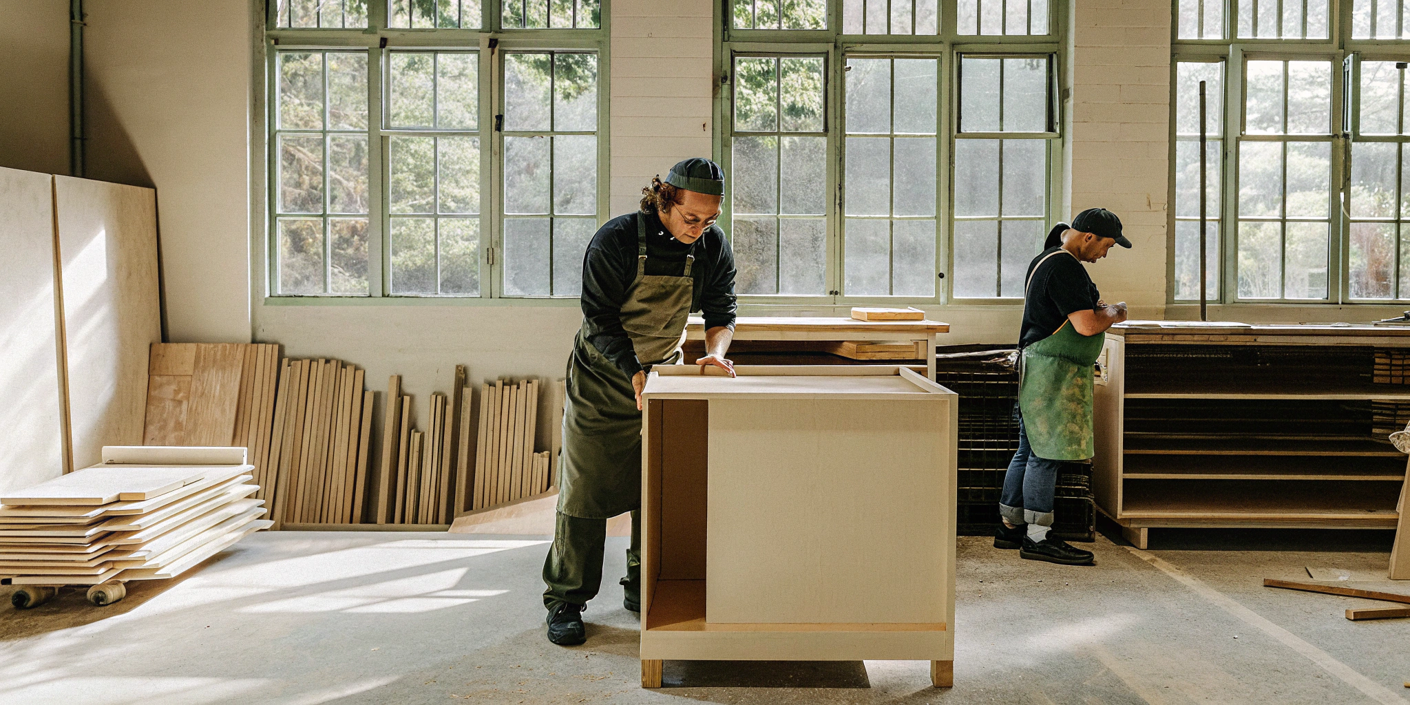 Two cabinet makers at work, a key part of the labor cost to build cabinets.