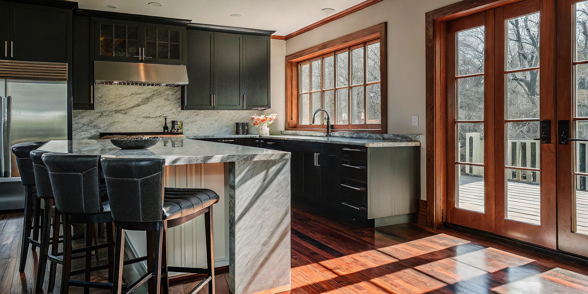 Modern kitchen with marble countertops and dark cabinets from a recent home renovation in Chicago.