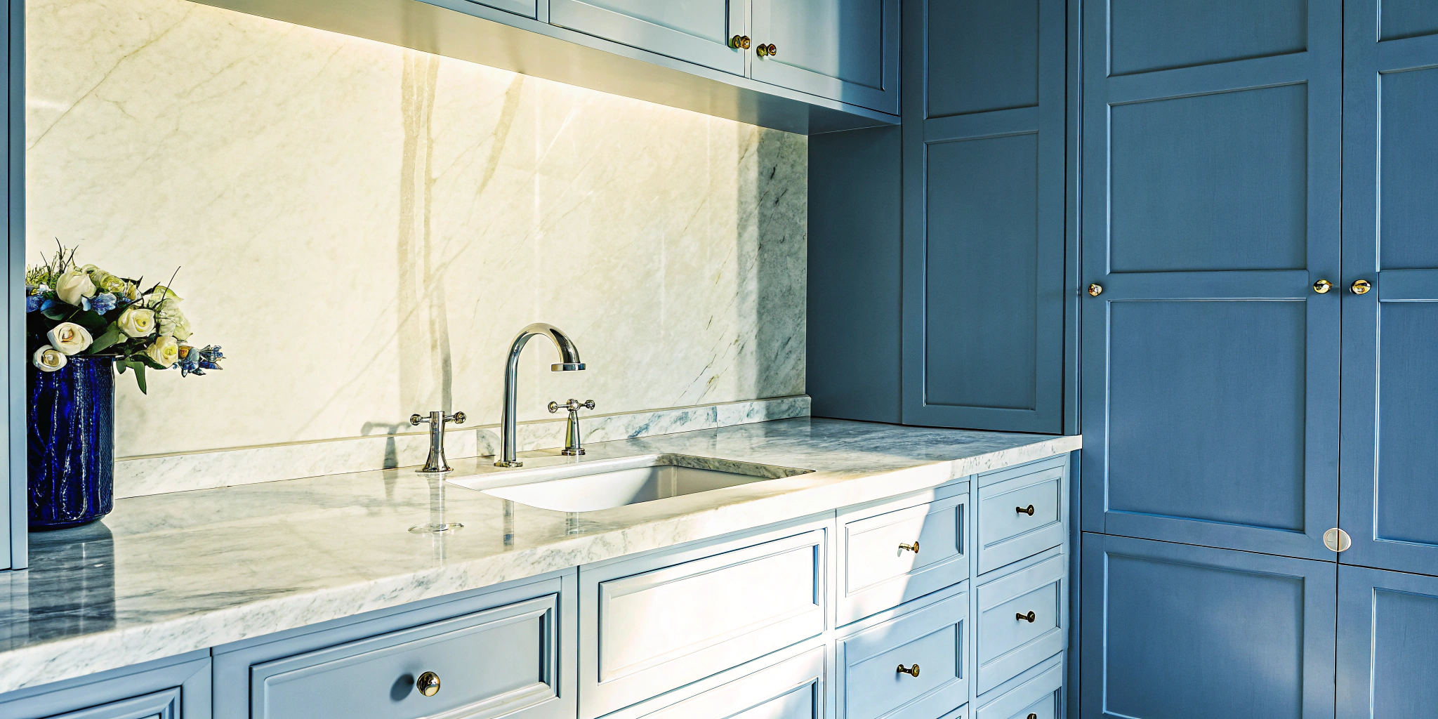 Kitchen remodel price breakdown for a modern kitchen with blue cabinets and marble countertops.