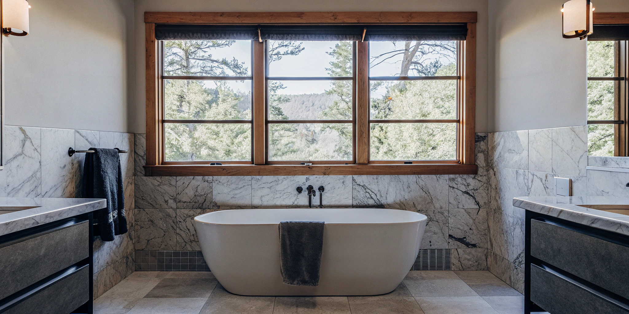 A modern bathroom remodeling project in Elmhurst featuring a freestanding tub and marble tile.